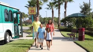 a family of four walking after riding in a trolley bus