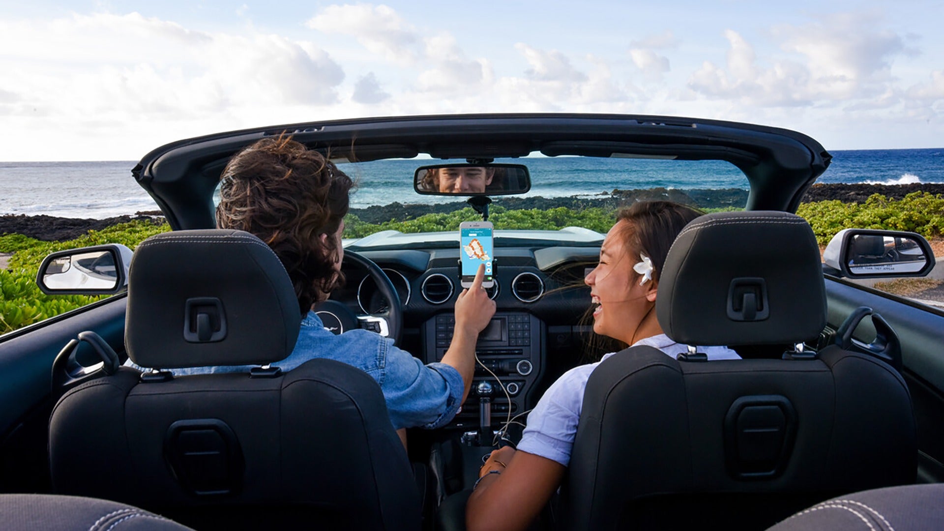 couple on a drive with a view of the ocean