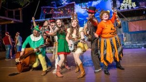 Group of singers on a stage in Christmas attire