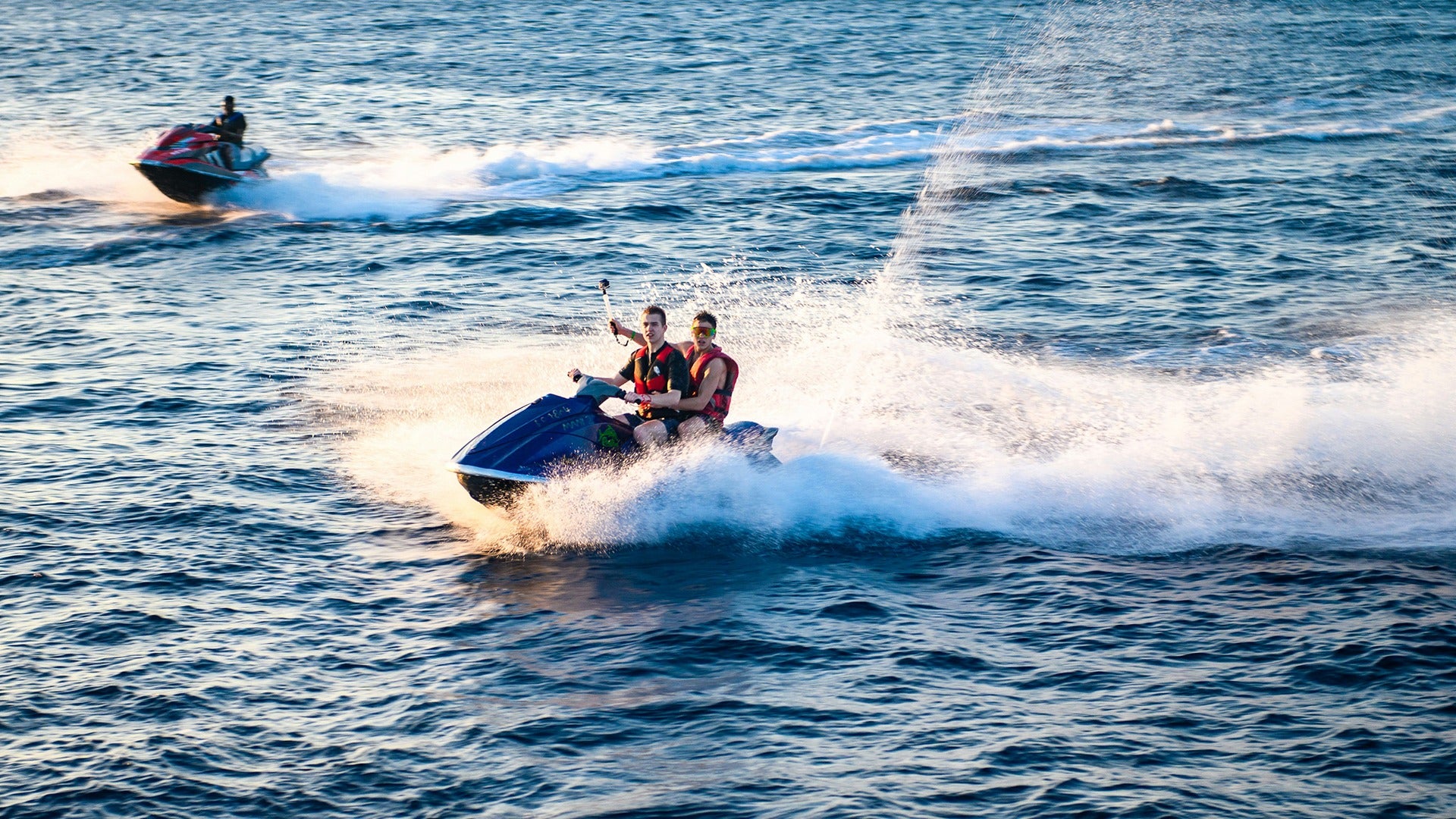two men on a jet ski in the ocean