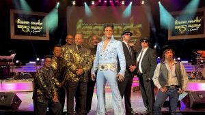 group of performers on stage in costumes