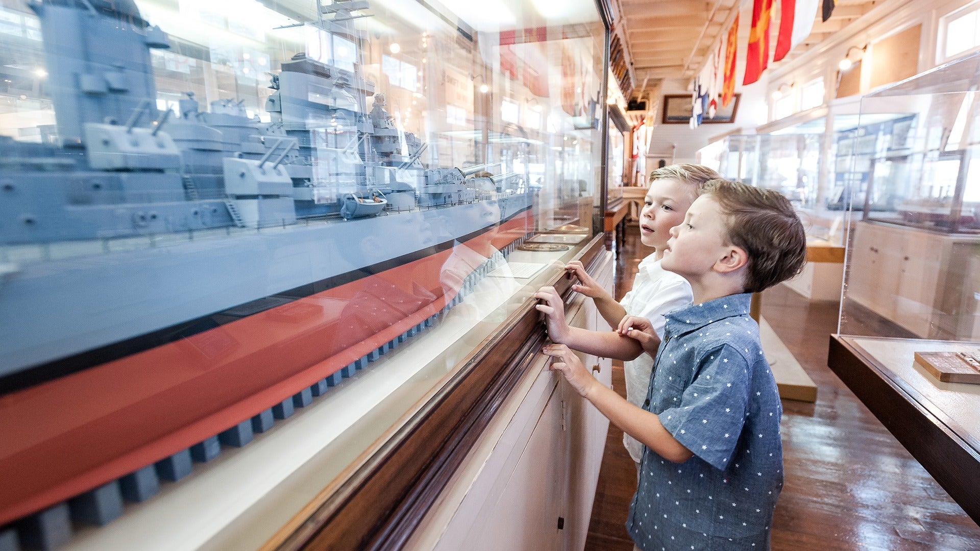 children looking up at a display of a ship