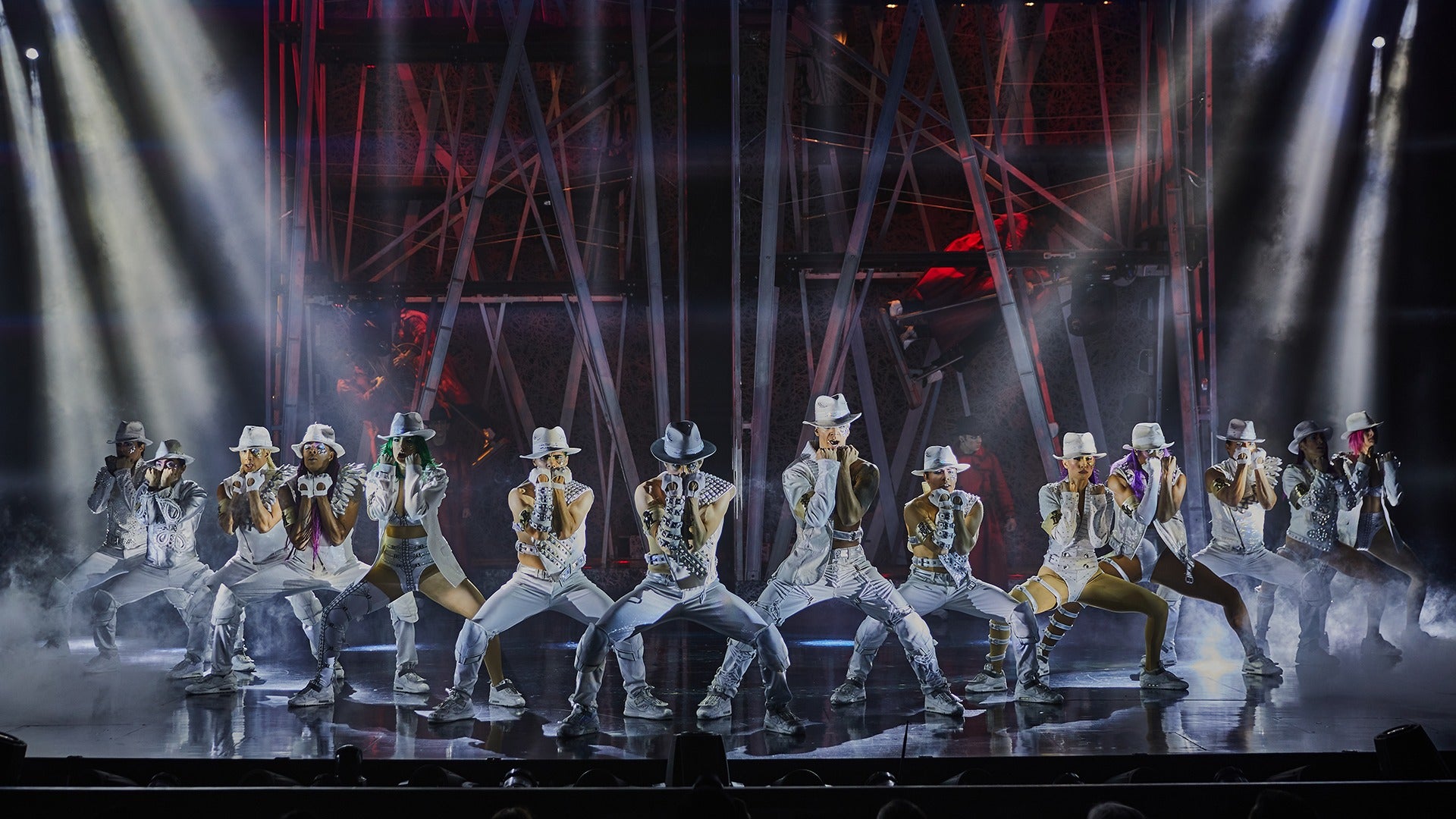 group of performers dancing on stage in costumes