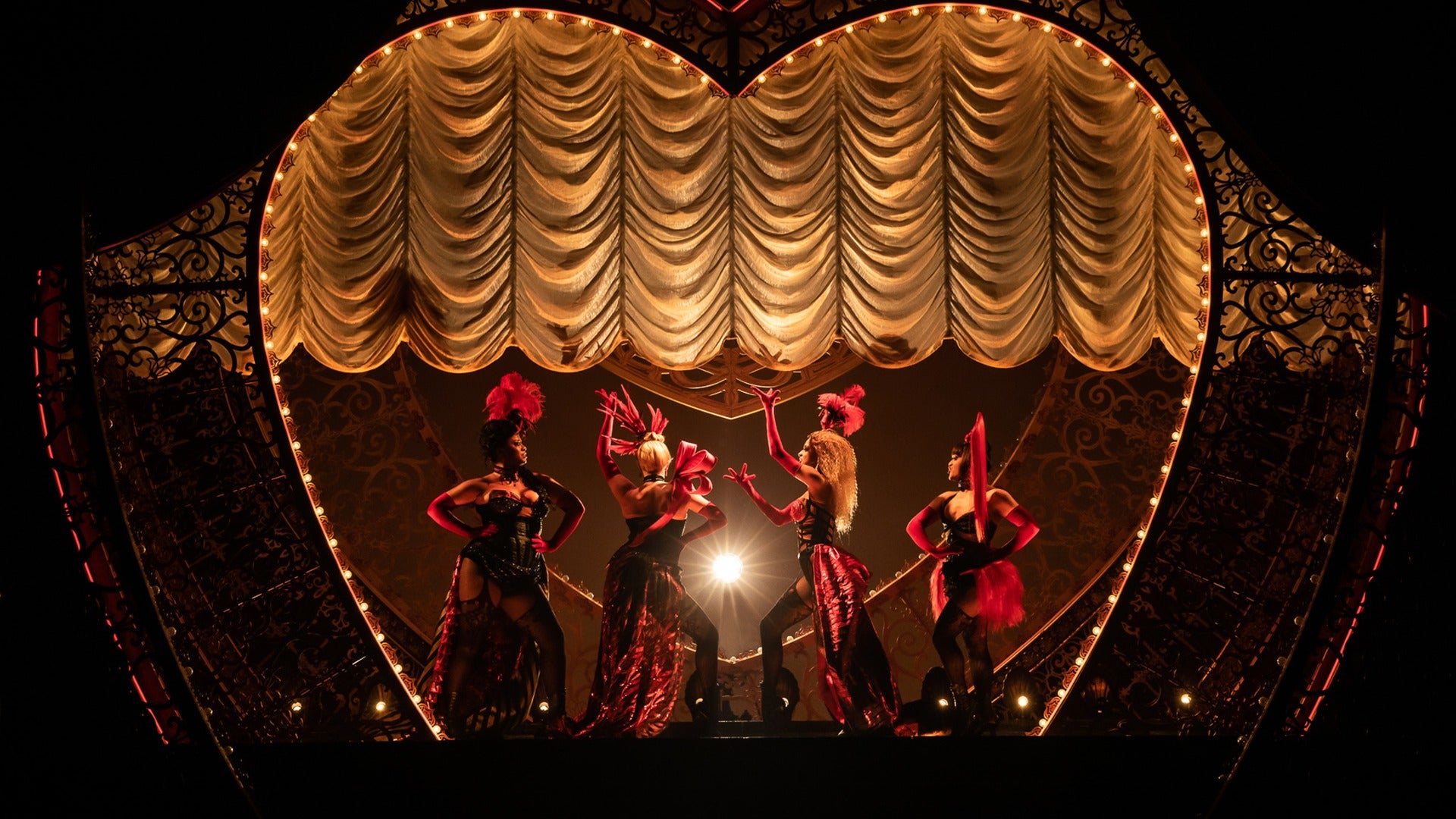 group of women in costumes on stage