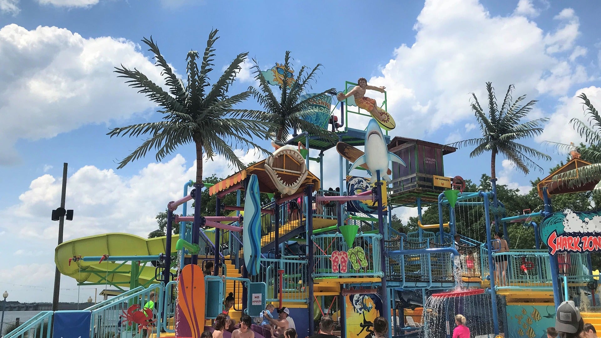 waterpark with families and children playing on the slides