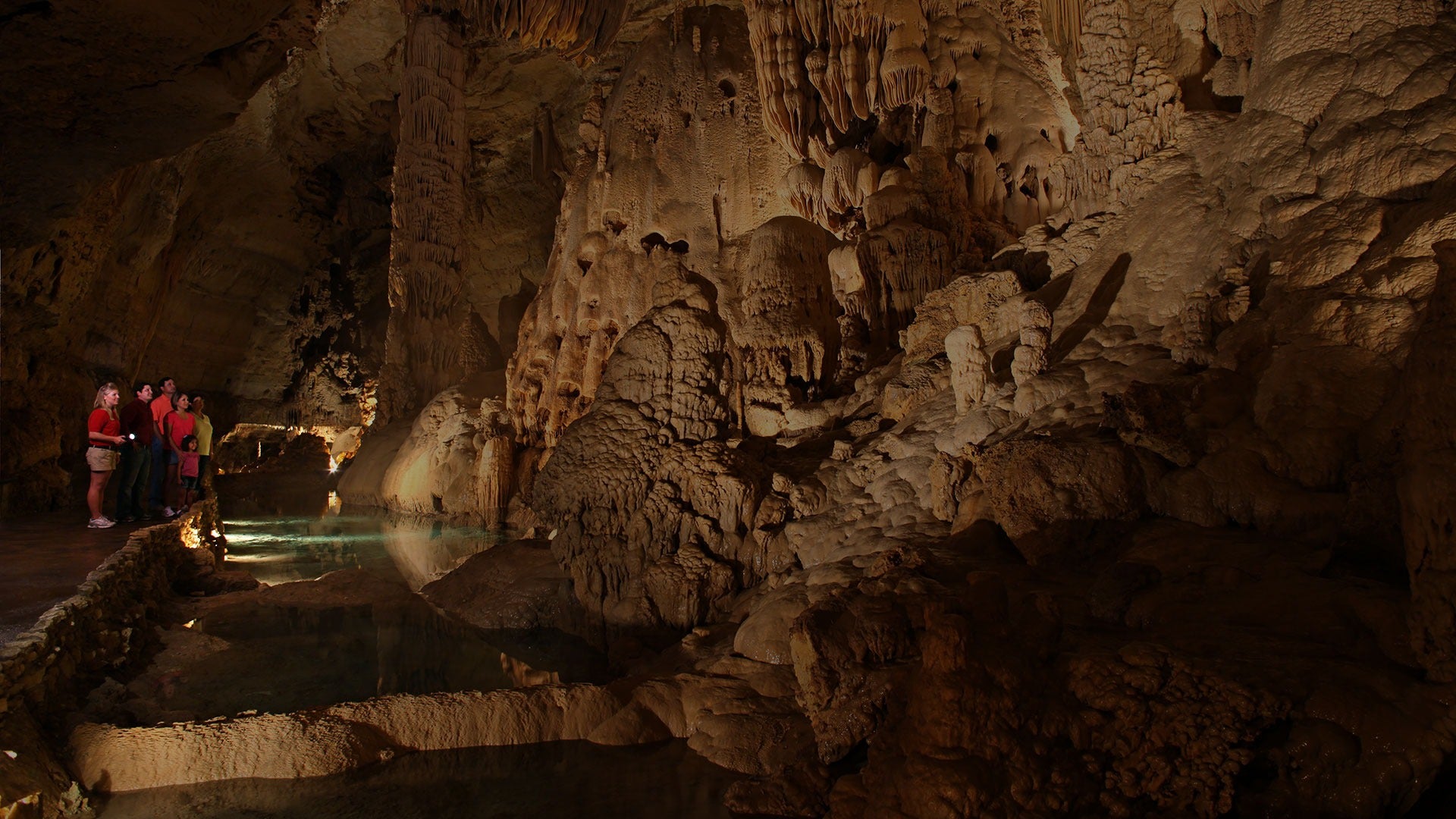 people in a cave admiring rock formations