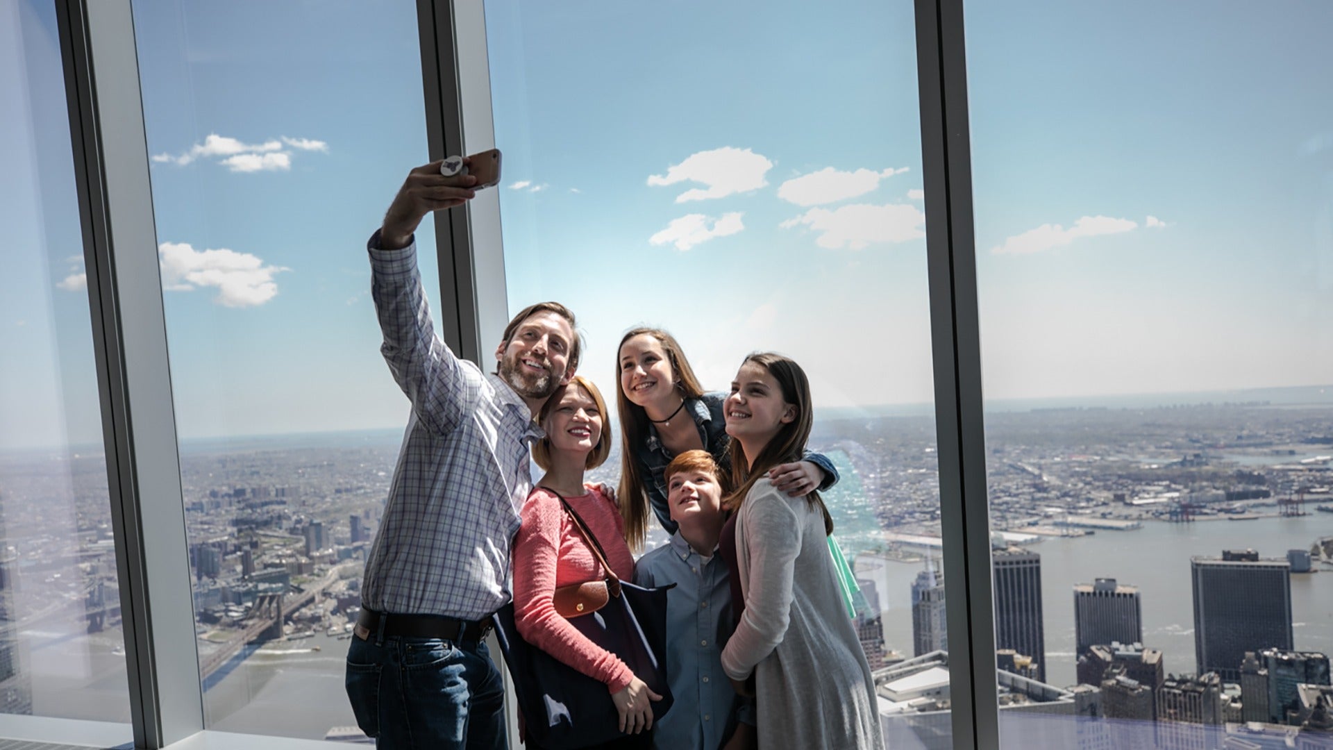 a family taking a selfie on a building observatory