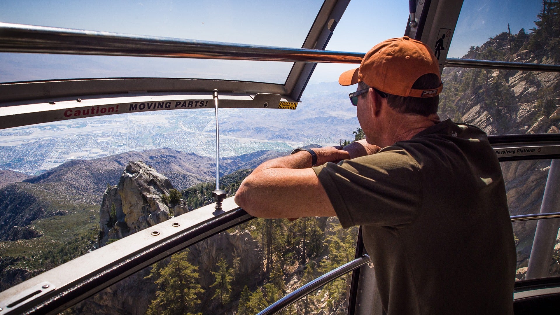 man looking at an aerial view of a city and forest