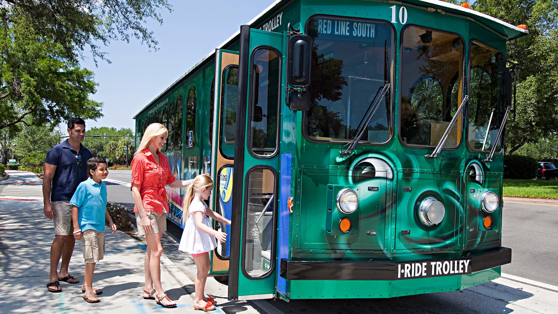 a family riding in a trolley bus