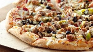 pizza topped with meat, olives, and other veggies
