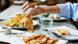 mexican food including quesadillas with someone picking one up