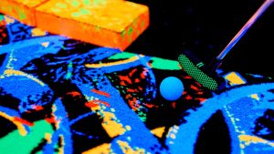 blacklight golf being hit by a club