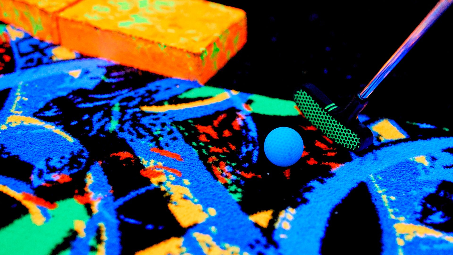 blacklight golf being hit by a club