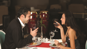a couple on a dinner date toasting wine