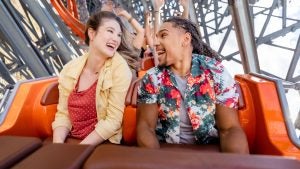 couple riding in the front of a roller coaster