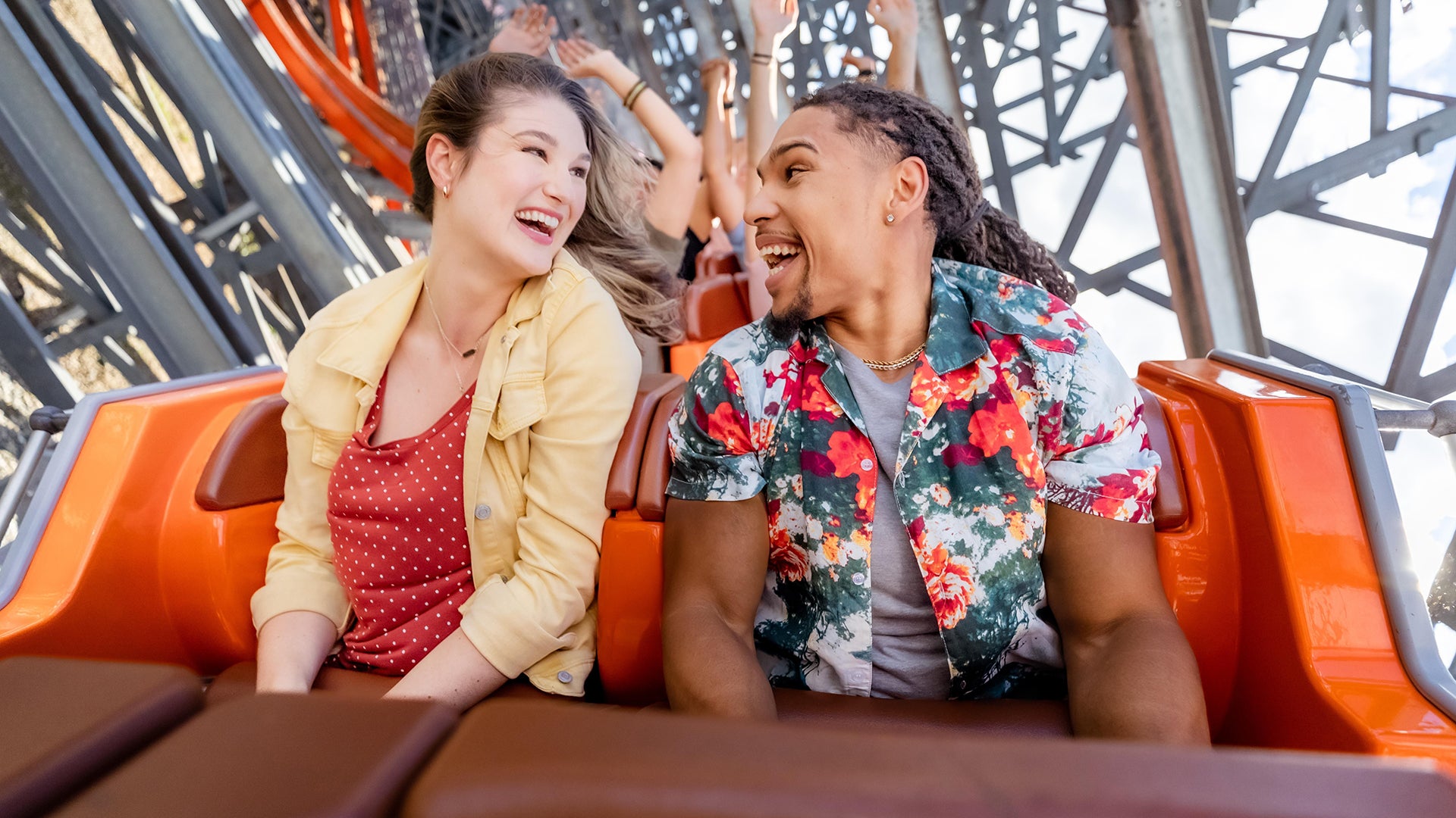 couple riding in the front of a roller coaster