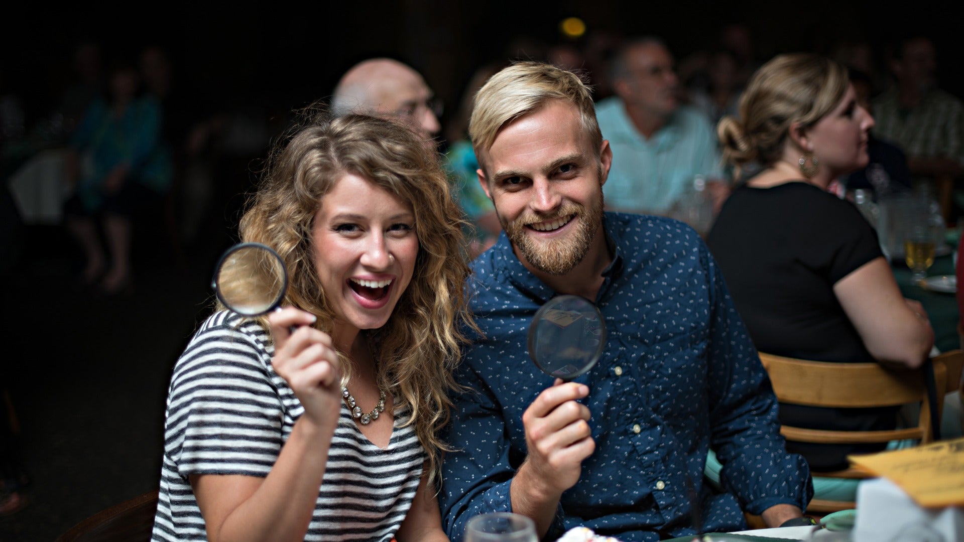 a couple holding magnifying glasses