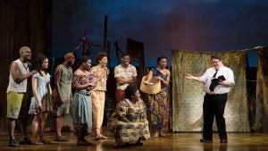 people in costumes on stage with props