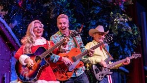 a group of performers holding instruments on stage