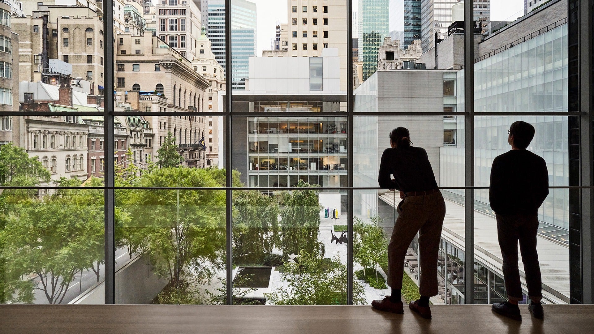 floor to ceiling glass windows with people looking out at it