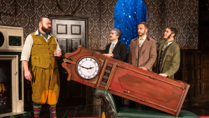 men in costumes on stage carrying a grandfather clock
