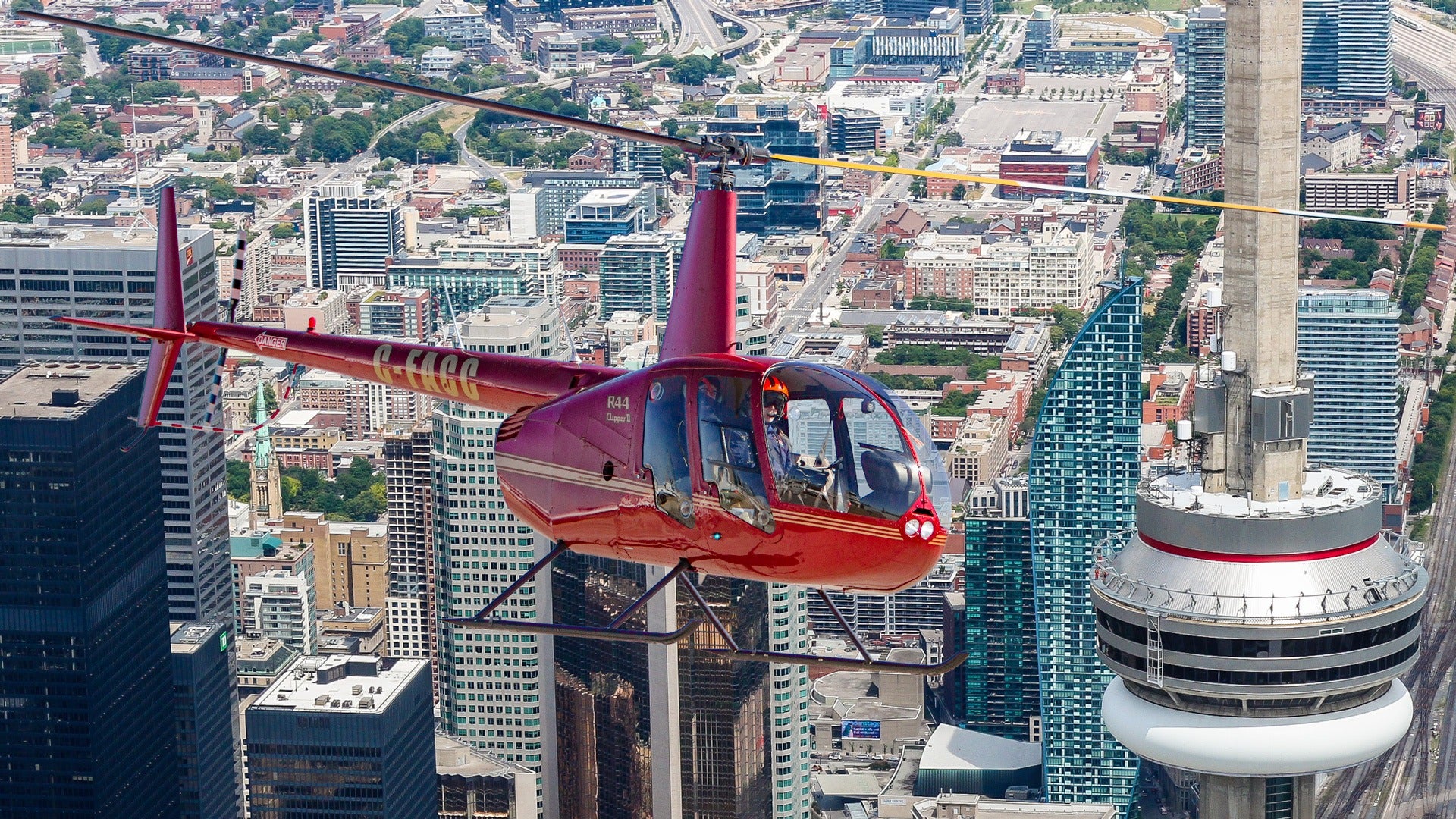 helicopter flying over toronto with a view of cn tower
