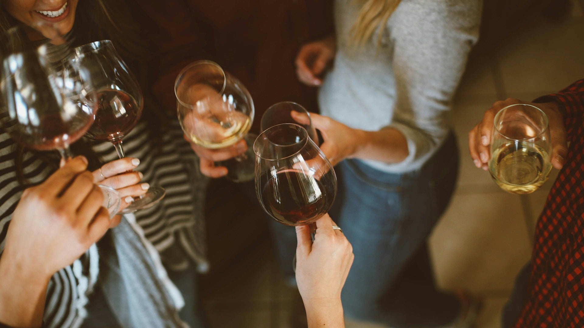 group of girls toasting and tasting wine