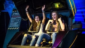 two girls seated in a ride