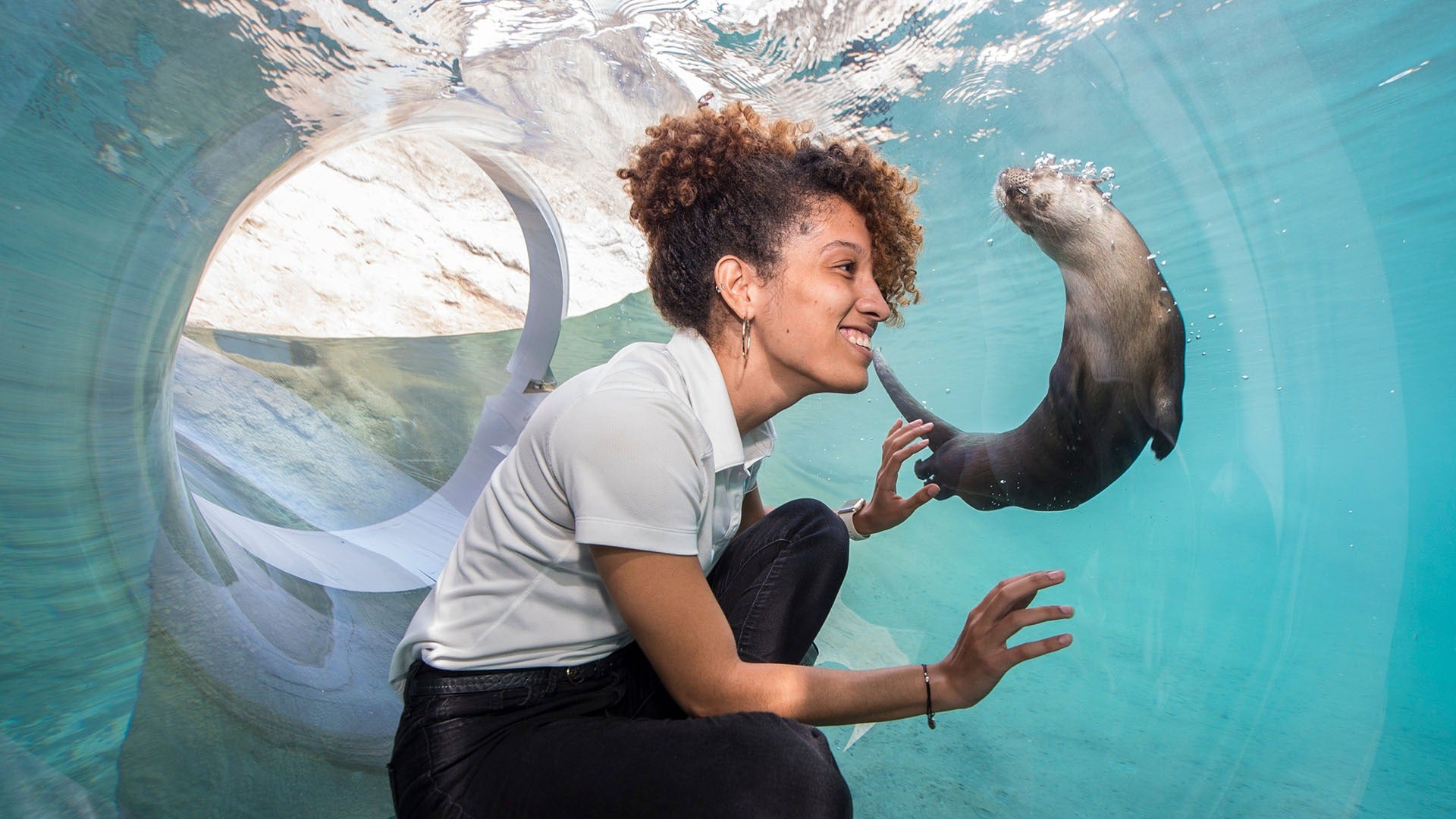 a girl with a baby otter