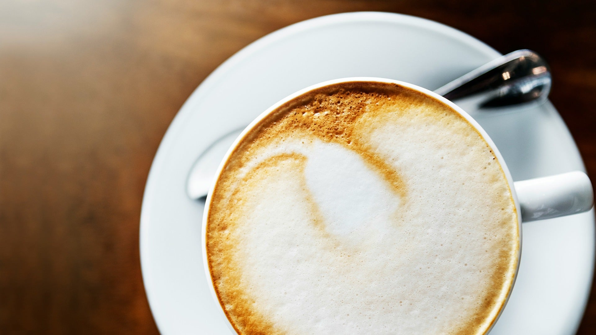 cup of cappuccino with stirrer