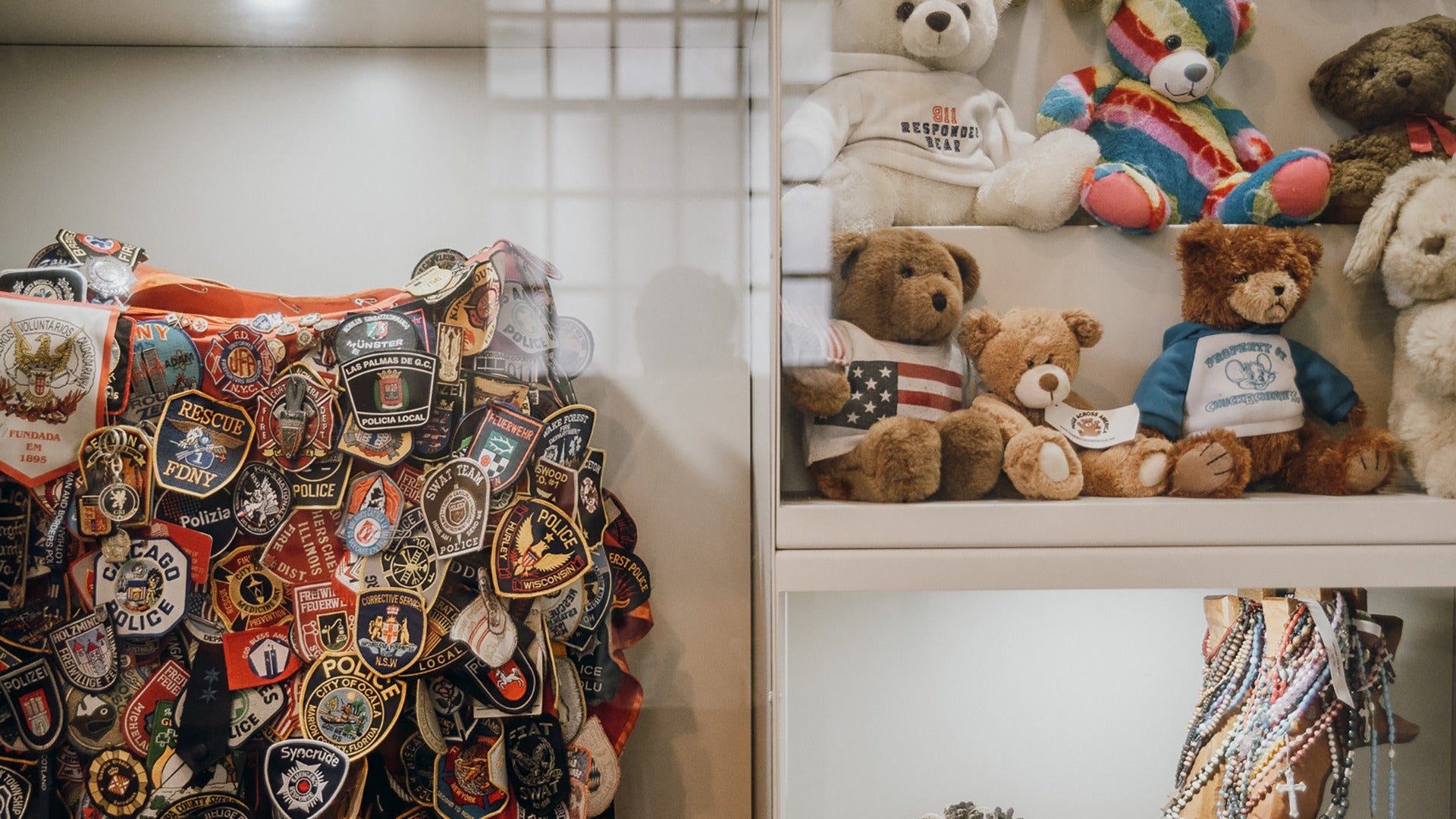 firemen patches and teddy bears in a display case