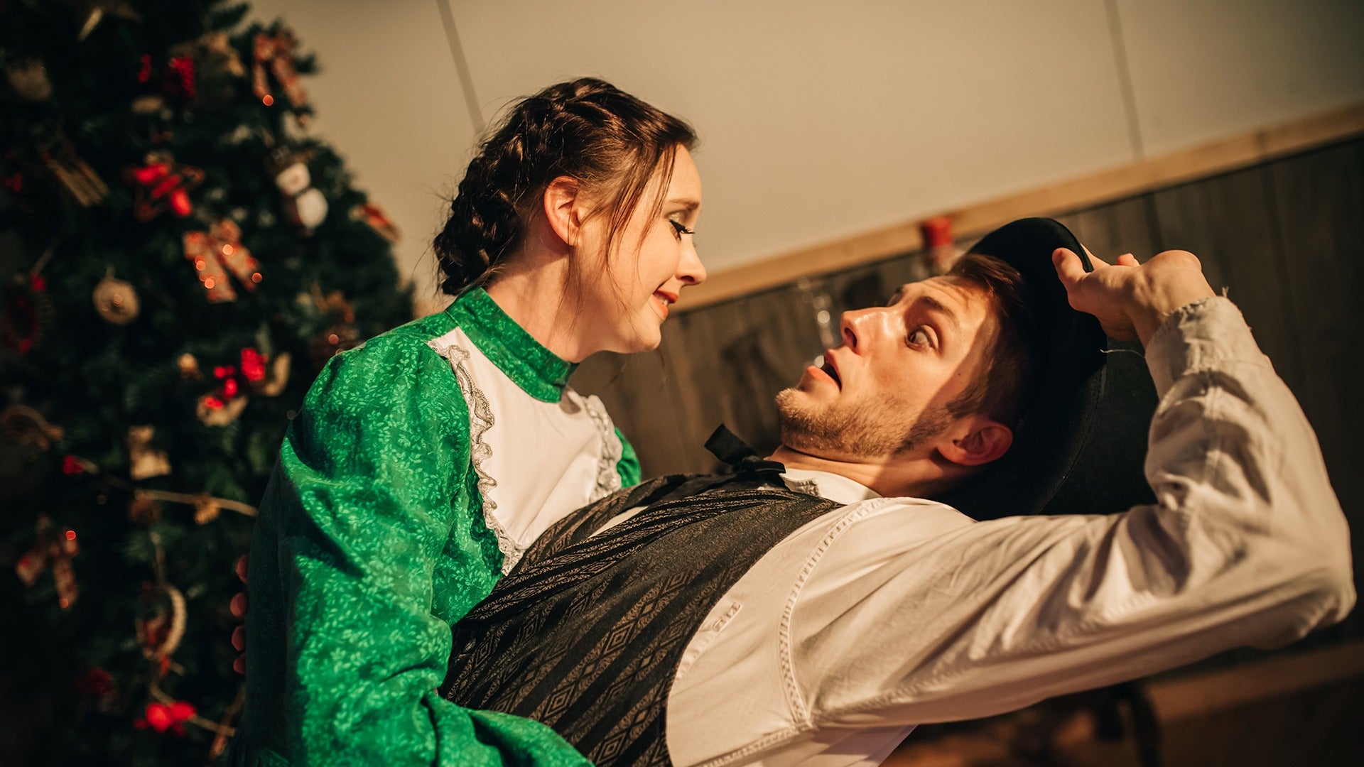 actors on stage wearing christmas themed outfits