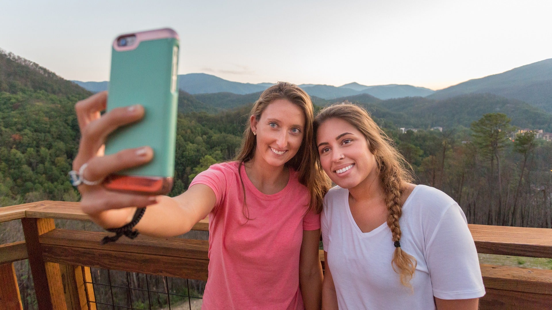 two girls taking a selfie at a scenic overlook
