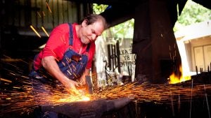 a man forging metal in dollywood
