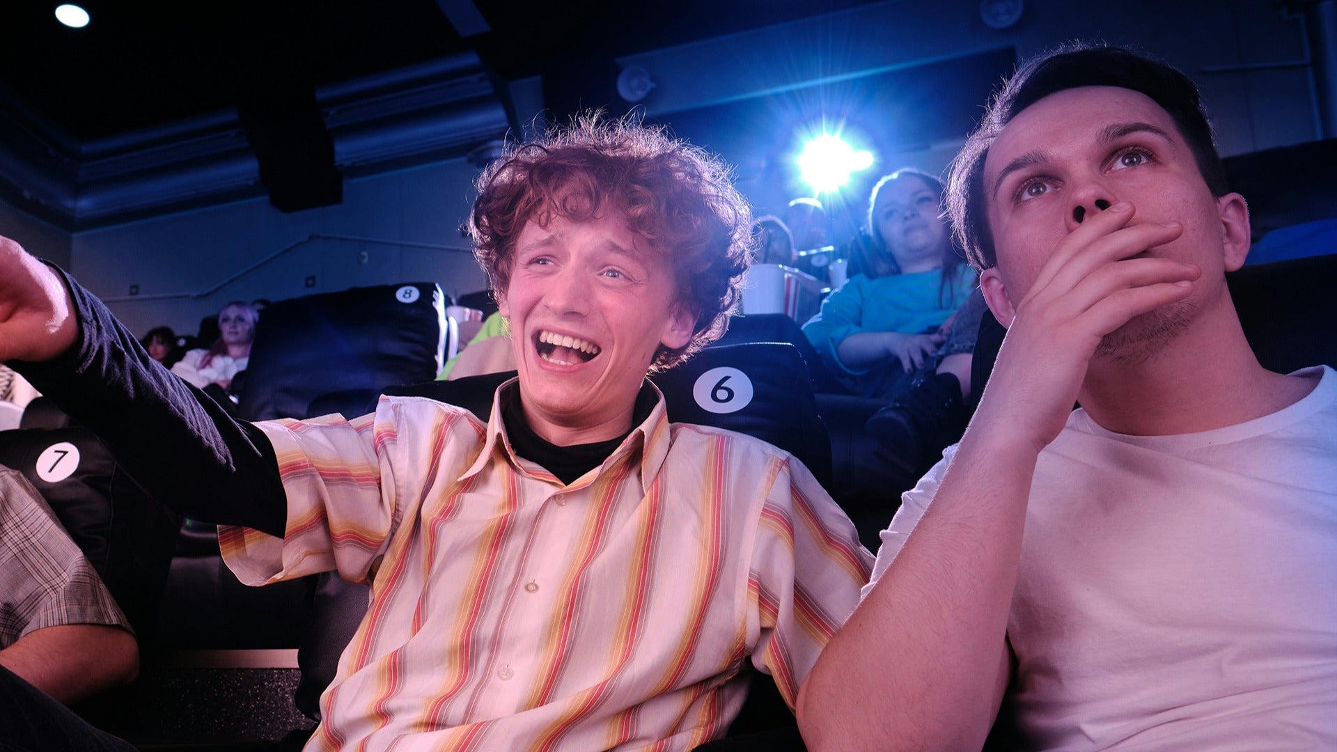 audience members watching a show and laughing