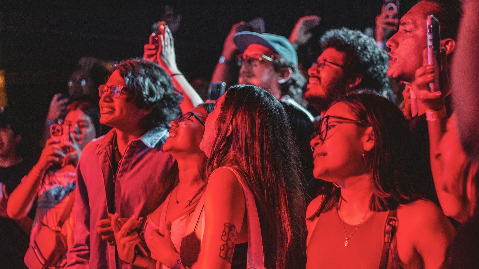 audience watching a concert and taking photos