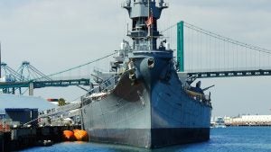 a gray ship docked on the harbor