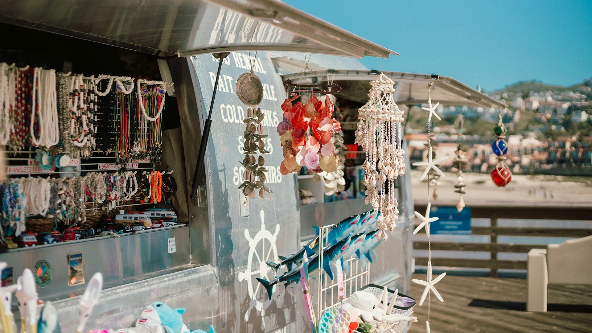 a store that sells shell chimes, necklaces, bracelets, and more on the beach