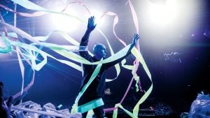 a blue man member strewn with ribbons