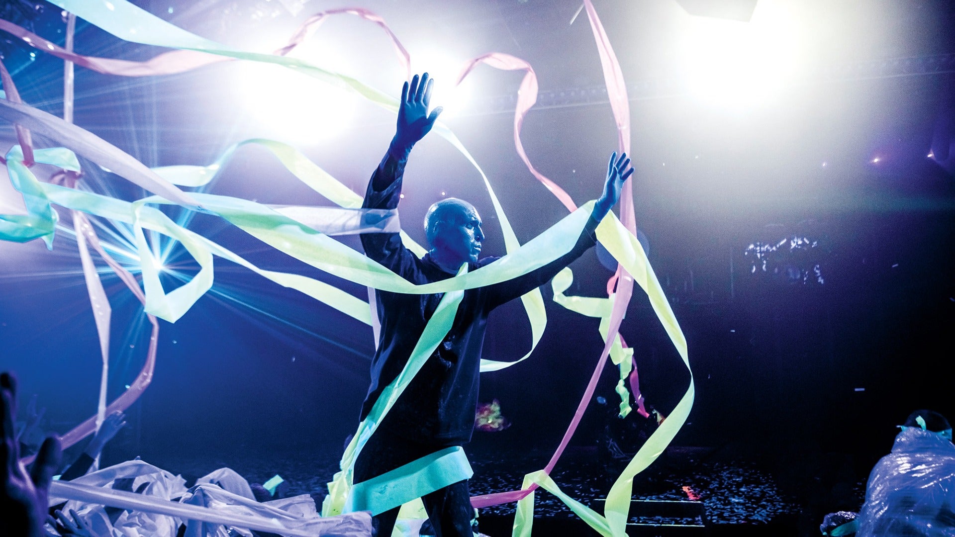 a blue man member strewn with ribbons