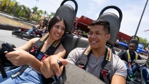 a couple riding go karts and having fun