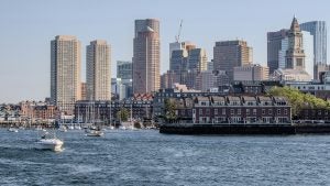 a harbor with a view of the city behind and boats on the water