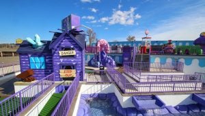 a purple golf course with various obstacles