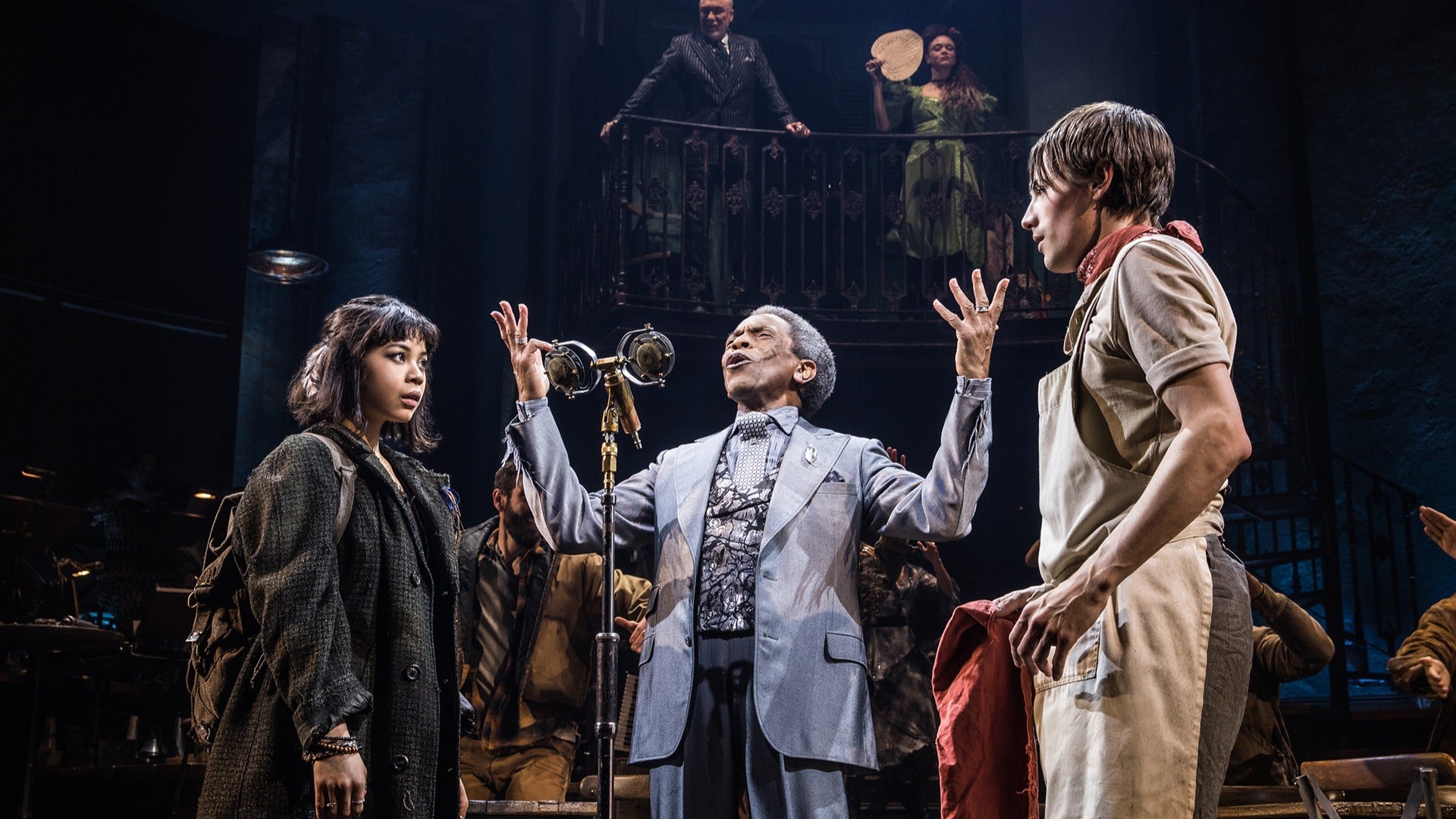 a group of stage actors in costumes portraying a scene