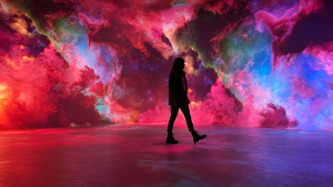 a woman in an illusion museum with differently colored projections