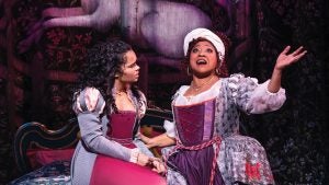 two women in costumes on stage