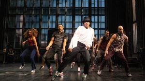 performer impersonating michael jackson with backup dancers at the back