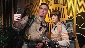 wax figures of a man and a woman in ghostbusters uniforms