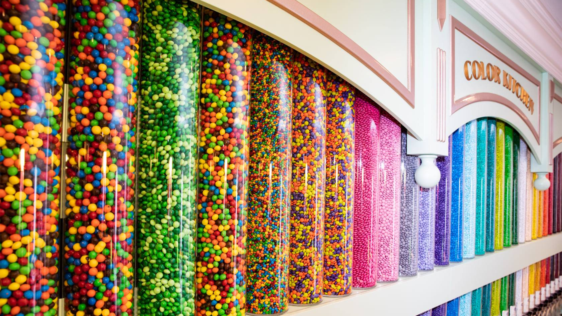 various colored m&m chocolates in a wall display