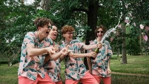 boys popping champagne and having fun